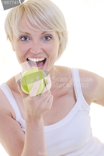Image of happy  young  woman eat green apple isolated  on white