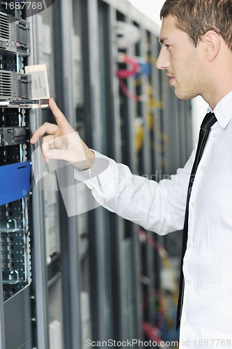 Image of young it engeneer in datacenter server room