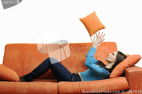 Image of happy woman relax on orange sofa