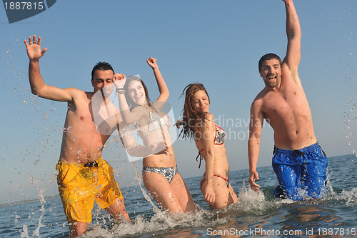 Image of happy people group have fun and running on beach