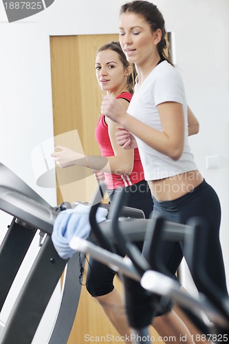 Image of woman workout  in fitness club on running track 