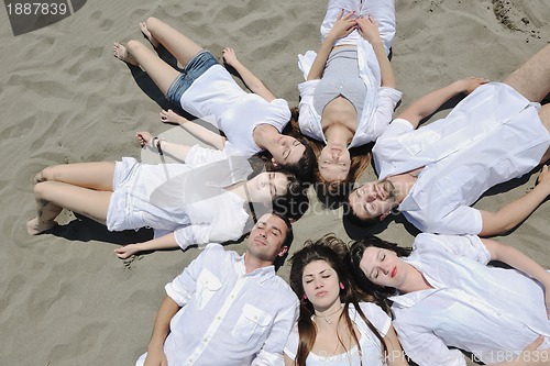 Image of Group of happy young people in have fun at beach