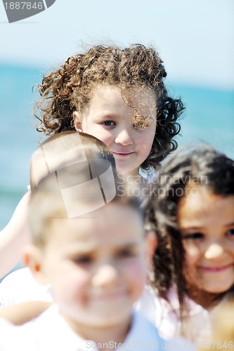 Image of happy child group playing  on beach