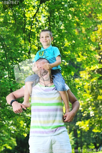 Image of happy father and son have fun at park