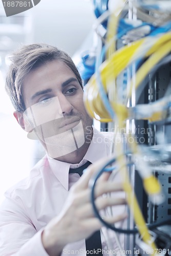 Image of young it engeneer in datacenter server room