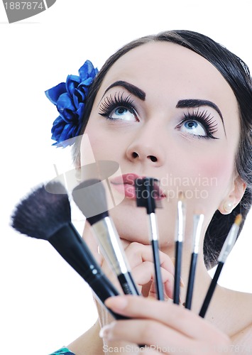 Image of beautiful young woman applying makeup