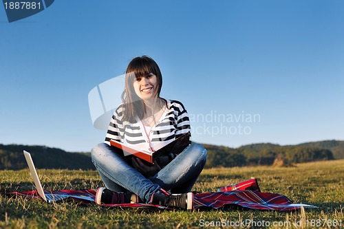 Image of young teen girl work on laptop outdoor