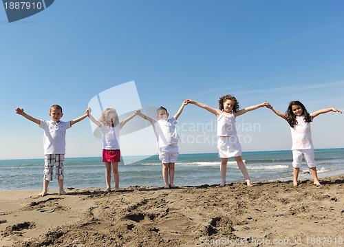 Image of happy child group playing  on beach