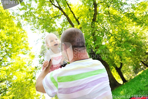 Image of man and baby playing in park