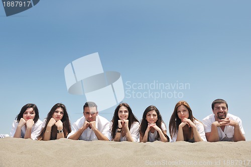 Image of Group of happy young people in have fun at beach