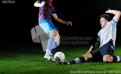 Image of football players in competition for the ball