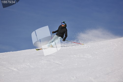 Image of woman skiing on fresh snow at winter season 