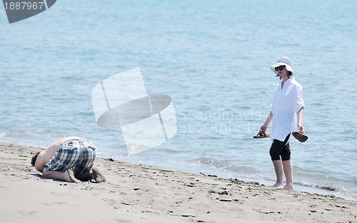 Image of happy young couple have fun on beach