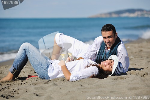 Image of young couple enjoying  picnic on the beach