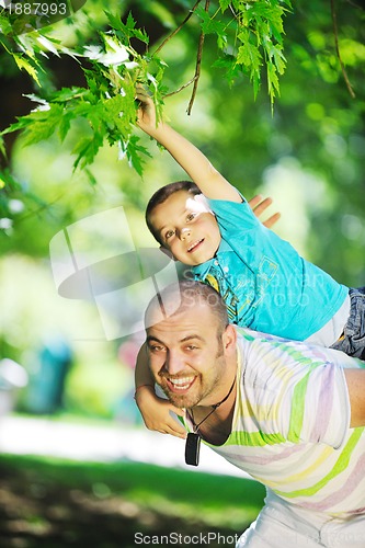 Image of happy father and son have fun at park