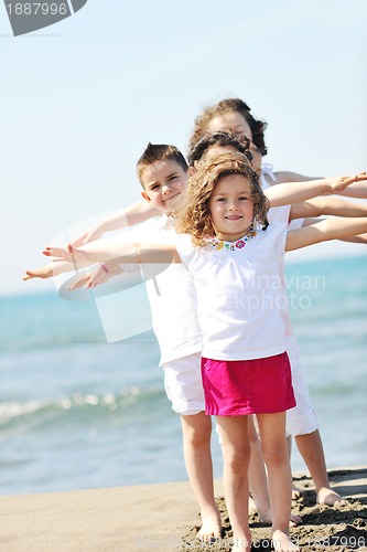 Image of happy child group playing  on beach