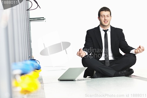 Image of business man practice yoga at network server room