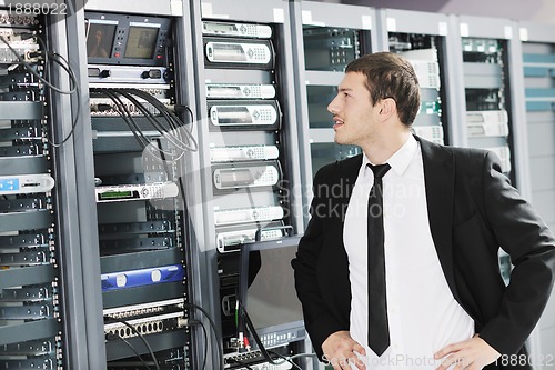 Image of young it engeneer in datacenter server room