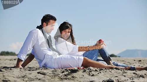 Image of young couple enjoying  picnic on the beach
