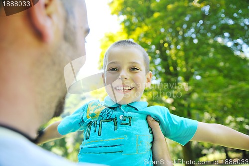 Image of happy father and son have fun at park