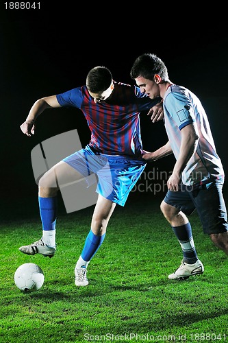Image of football players in competition for the ball