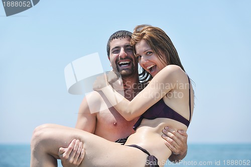 Image of happy young couple have romantic time on beach