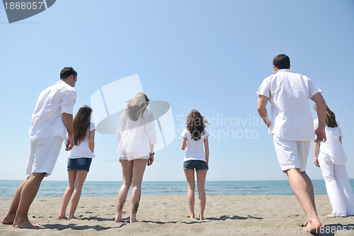 Image of happy people group have fun and running on beach
