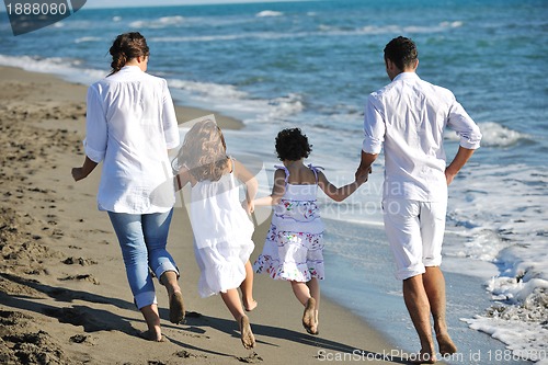 Image of happy young  family have fun on beach