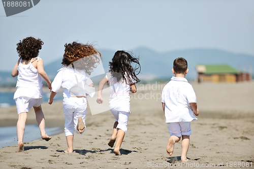 Image of happy child group playing  on beach