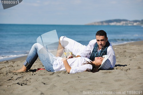 Image of young couple enjoying  picnic on the beach