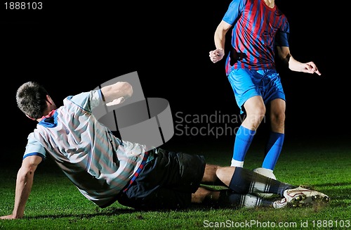 Image of football players in competition for the ball