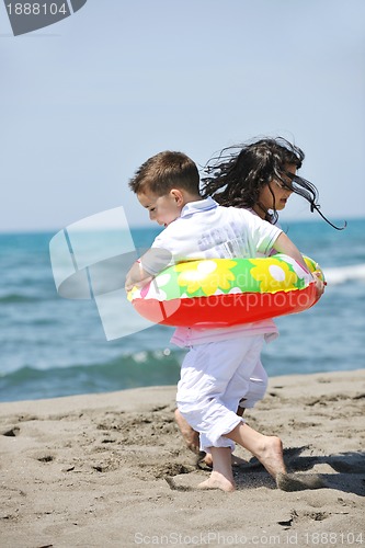 Image of happy child group playing  on beach