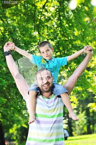 Image of happy father and son have fun at park