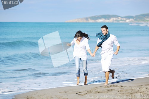 Image of happy young couple have fun at beautiful beach