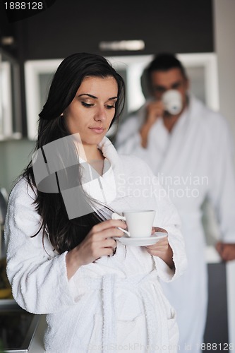 Image of Young love couple taking fresh morning cup of coffee