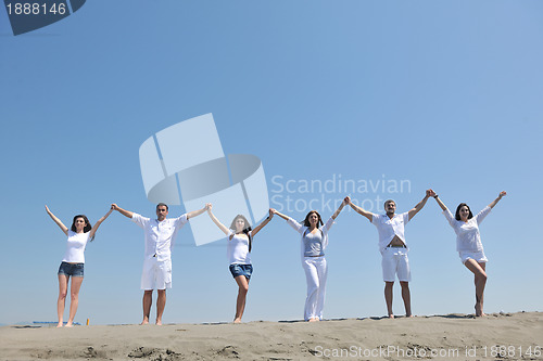 Image of happy people group have fun and running on beach