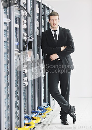 Image of young it engeneer in datacenter server room