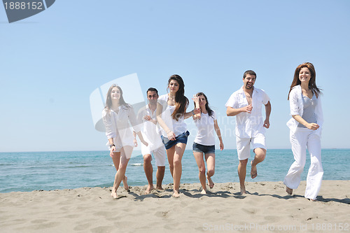 Image of happy people group have fun and running on beach