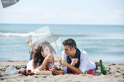 Image of young couple enjoying  picnic on the beach