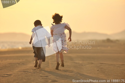 Image of happy young family have fun on beach at sunset