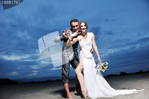 Image of romantic beach wedding at sunset