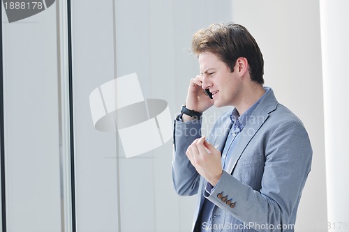 Image of young business man talk by cellphone