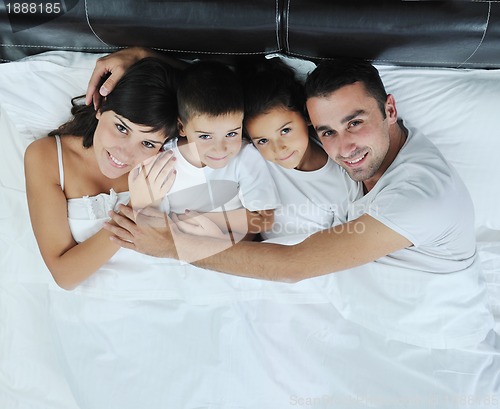 Image of happy young Family in their bedroom