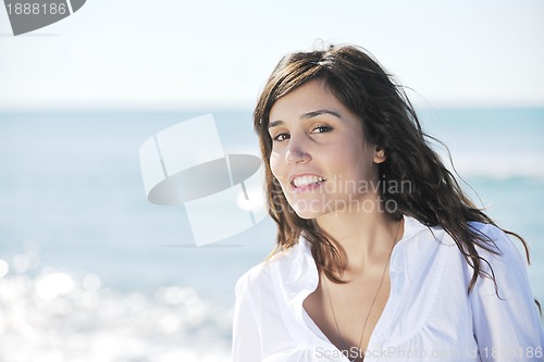 Image of happy young woman on beach