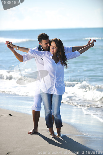 Image of happy young couple have fun at beautiful beach