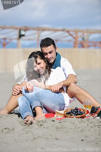 Image of young couple enjoying  picnic on the beach