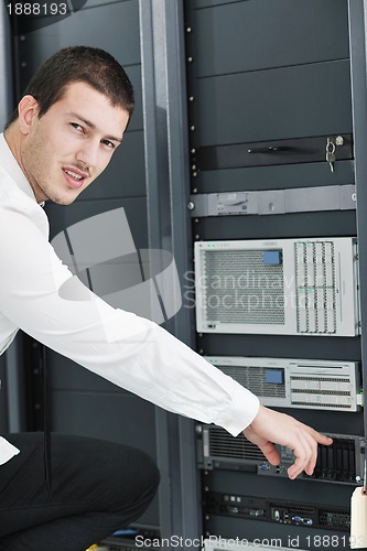 Image of young it engeneer in datacenter server room