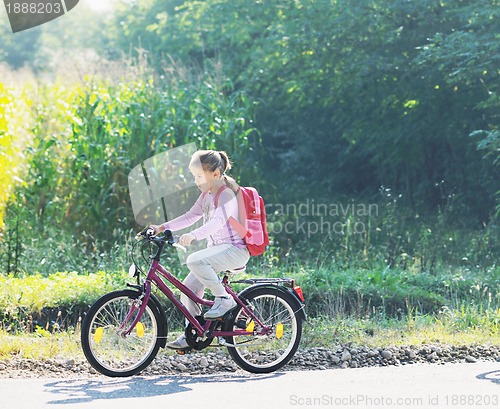 Image of schoolgirl traveling to school on bicycle