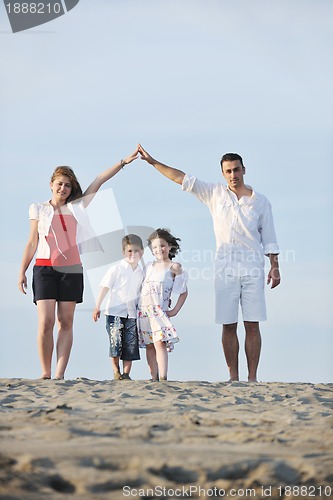 Image of family on beach showing home sign