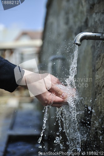 Image of fresh mountain water falling on hands